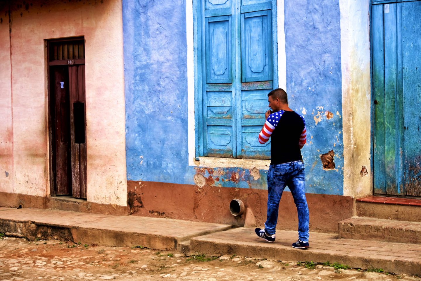 Cuban man wearing an American-flag shirt. Trinidad. Daily life in Cuba