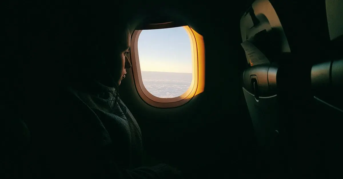 A calm airplane cabin with a relaxed passenger, symbolizing practical steps to overcome your fear of flying and embrace air travel with confidence and peace of mind.