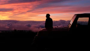 Mindful traveler journaling at sunrise, embracing transformative travel mindset