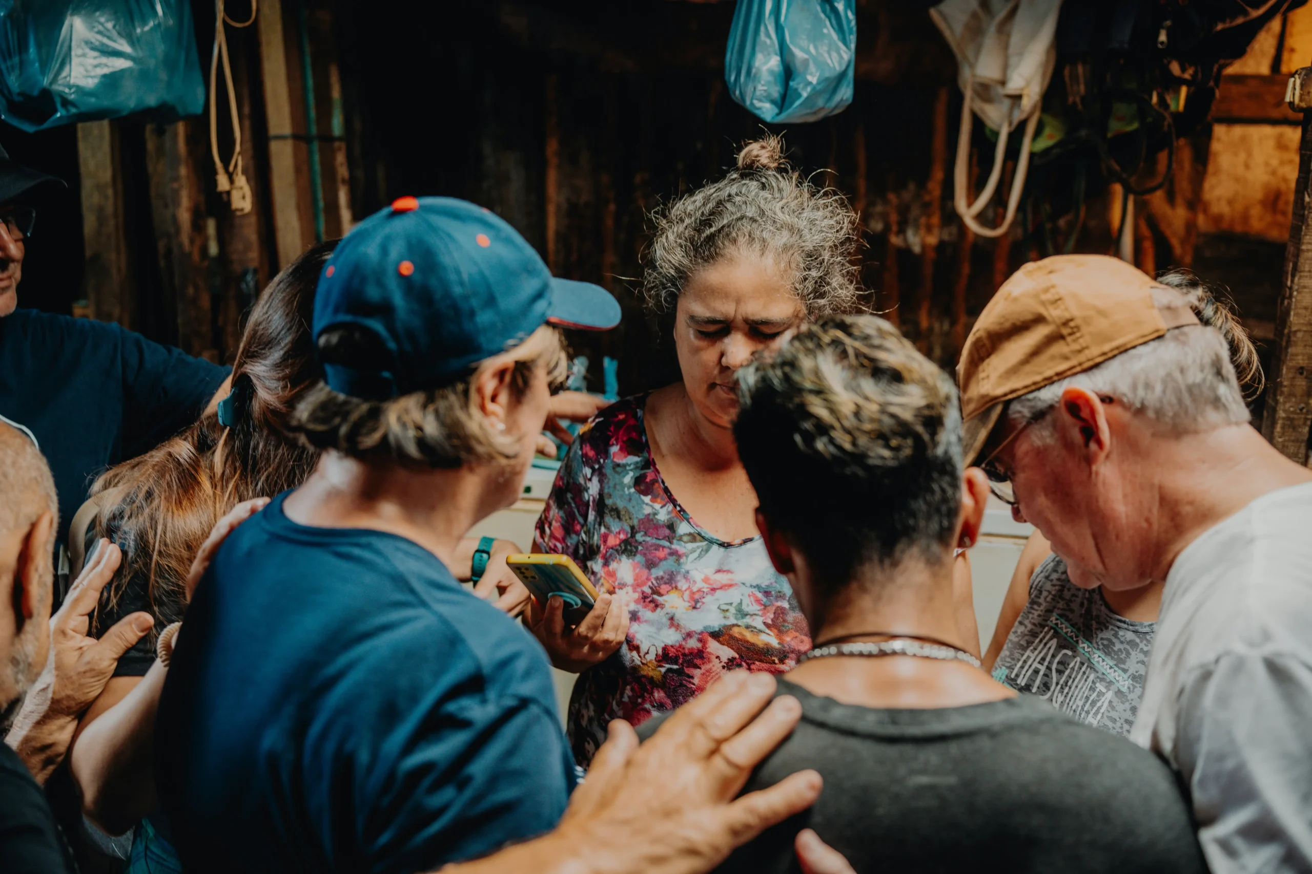 Community members supporting each other during difficult time, showing traditional support systems and cultural response patterns